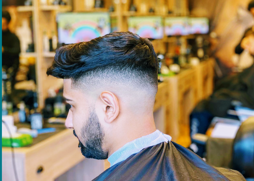 Fade haircut and beard trim photographed inside the barbershop