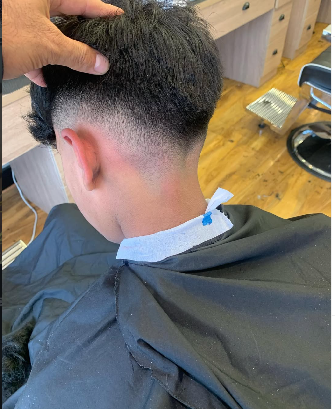 Back view of a low skin fade haircut inside the Amersham barbershop