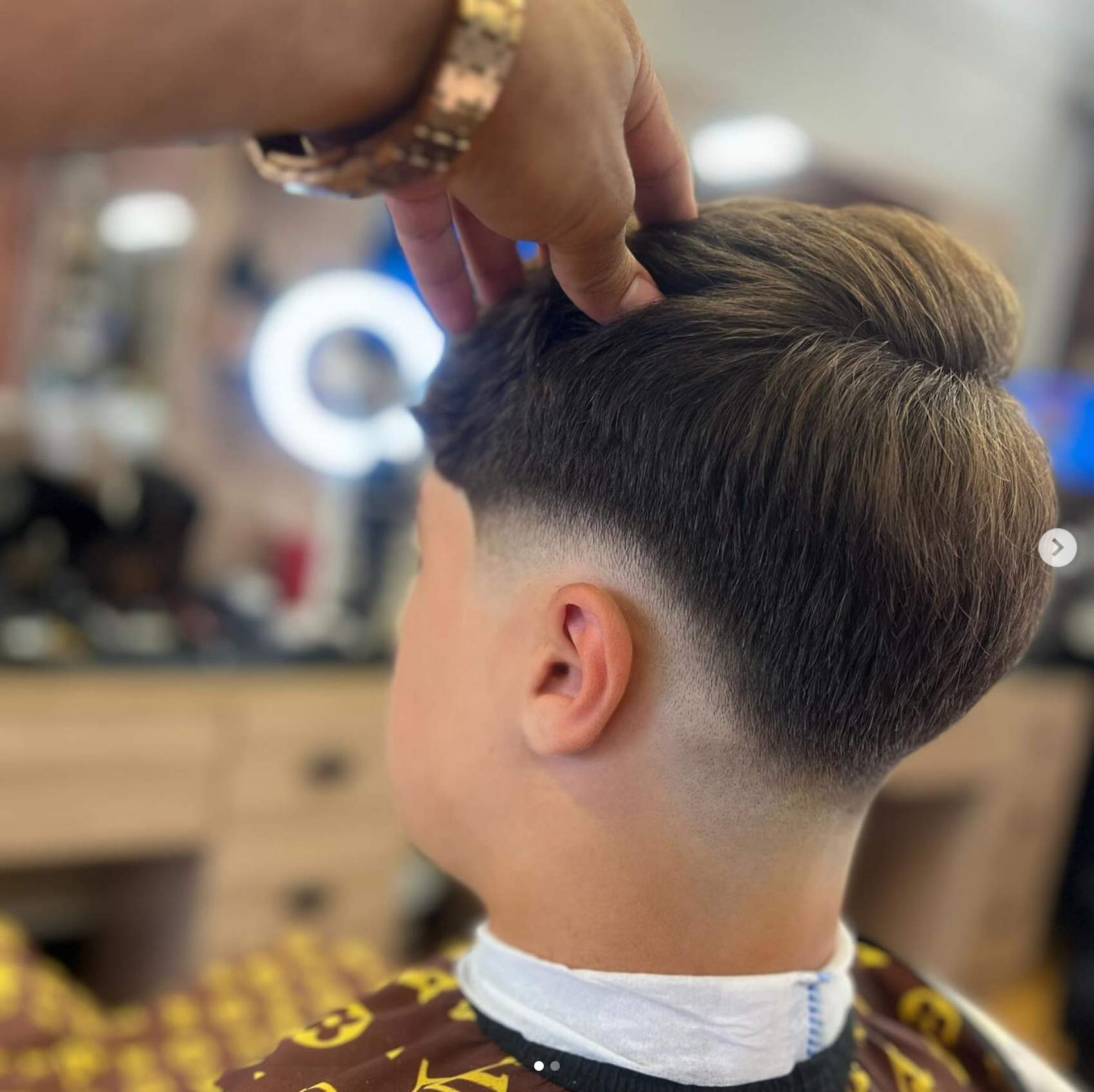 Clean blended fade with a longer textured top styled in the shop